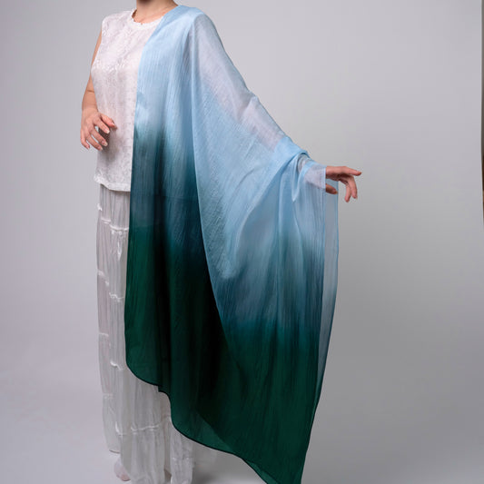Model wearing sky blue to emerald green ombre hand-dyed silk scarf draped over shoulders — Silk & Bears