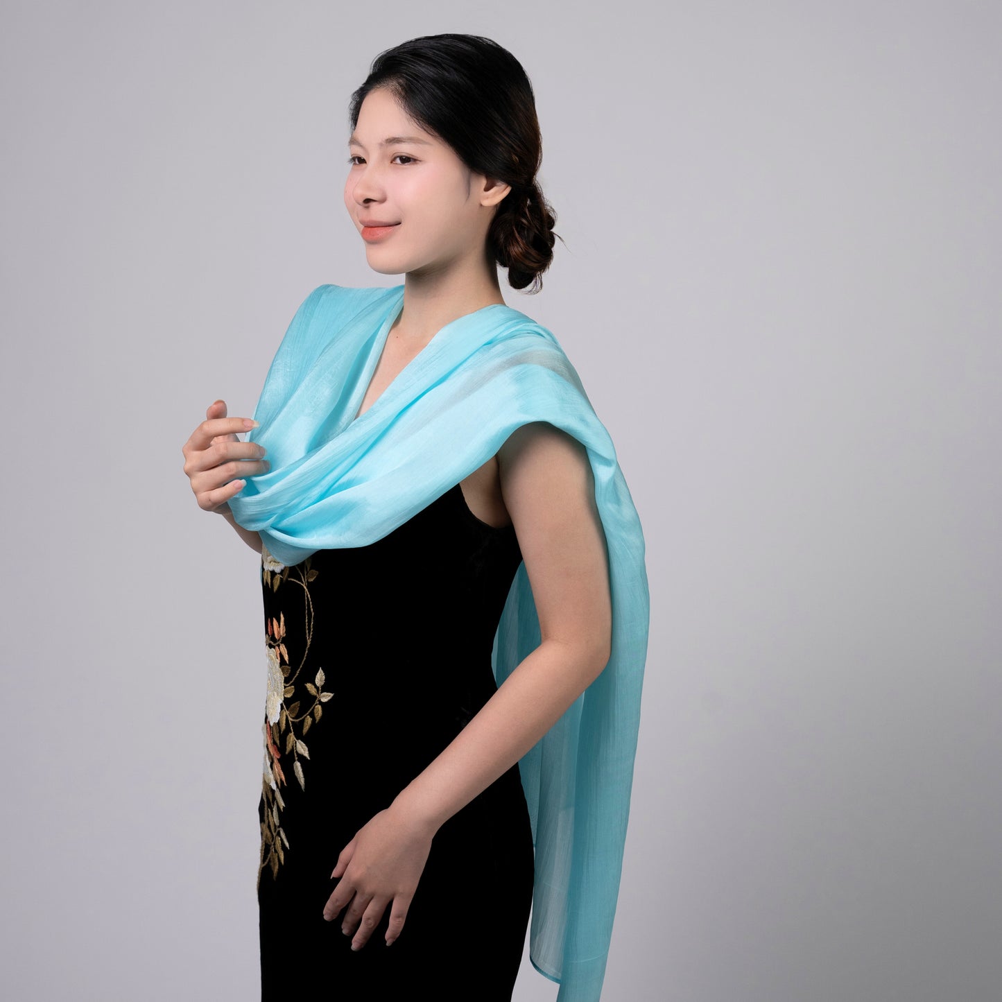 Close-up of the ice blue hand-dyed silk scarf, showing texture and lustre