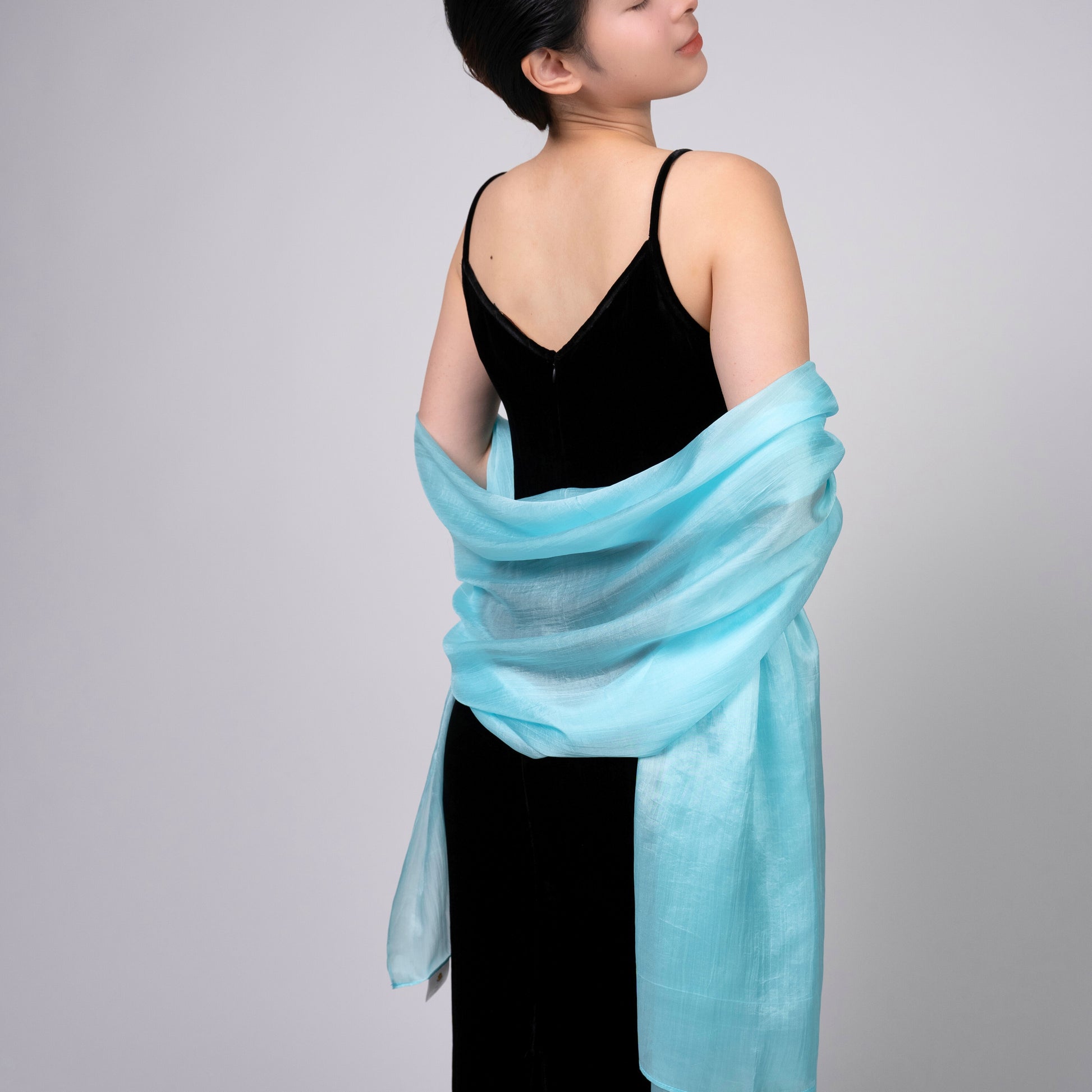 Ice blue silk scarf worn as a flowing shawl, hand-dyed mulberry silk