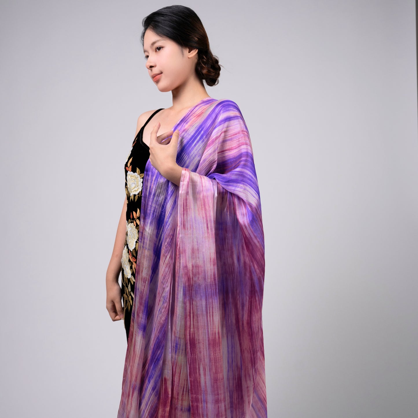 Purple and pink brushstroke mulberry silk scarf styled loosely around the neck