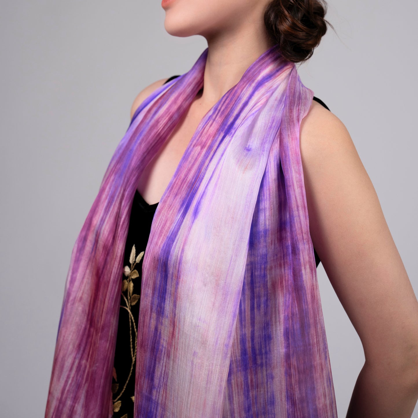 Close-up of the purple and pink brushstroke silk scarf, showing hand-painted texture and lustre