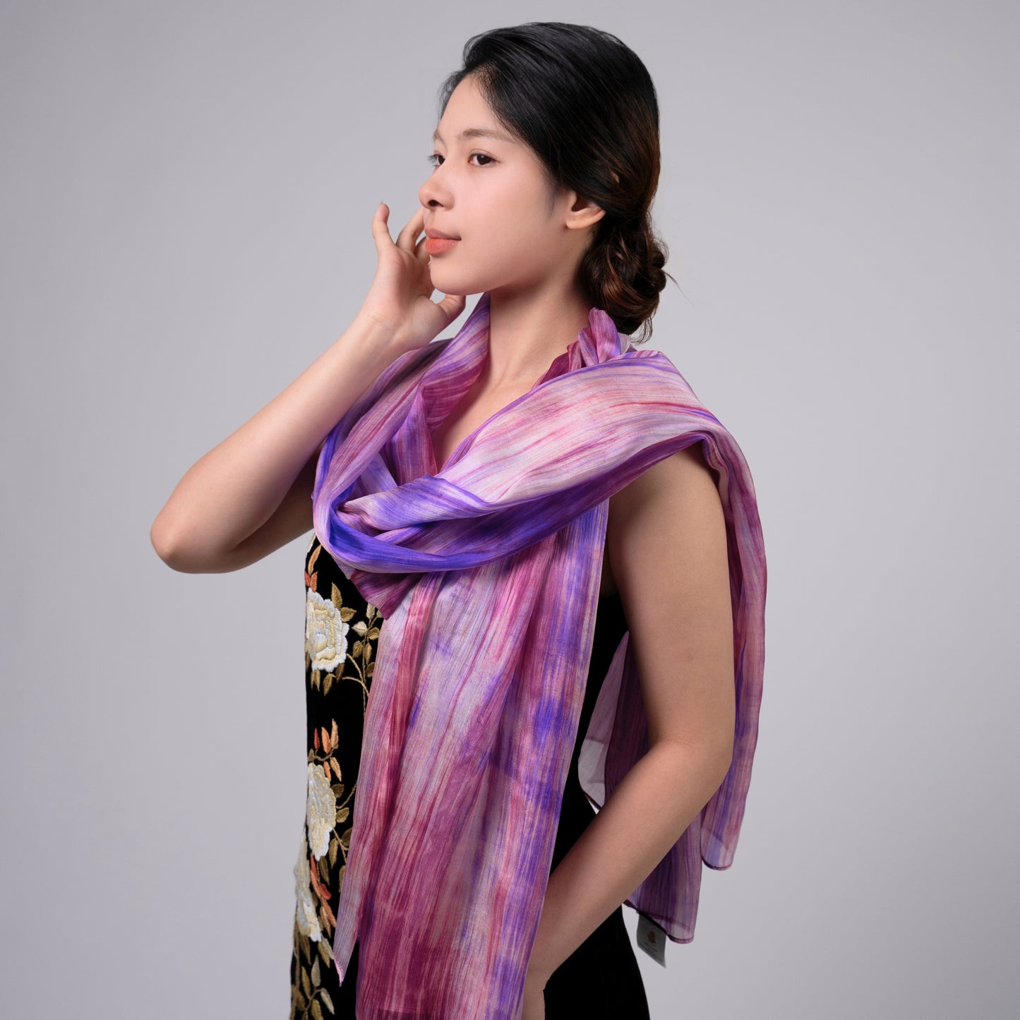 Purple and pink brushstroke silk scarf held open to show the full hand-painted design
