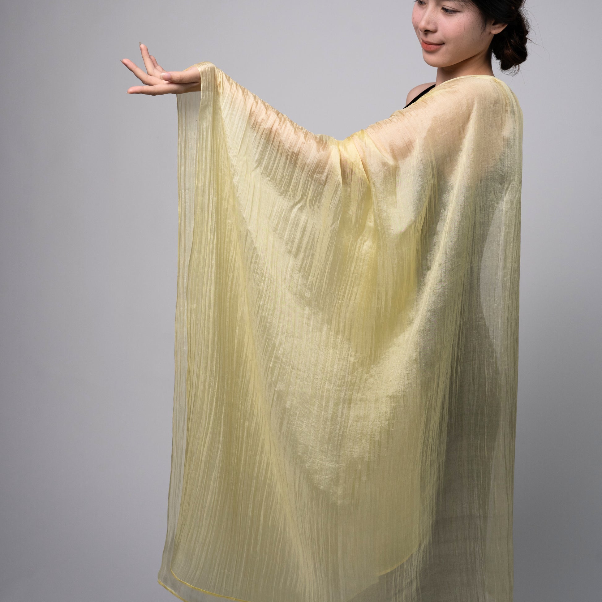 Back view of a model wearing the golden yellow silk shawl by Silk & Bears