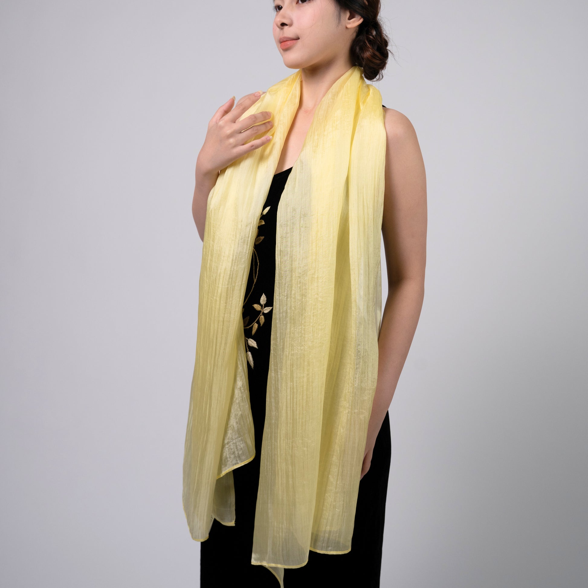 Golden yellow hand-dyed silk scarf held open to show the full warm colour