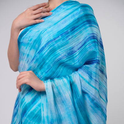 Sky blue brushstroke silk scarf worn as a flowing shawl, hand-dyed mulberry silk