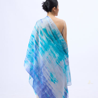 Model wearing a sky blue brushstroke hand-dyed silk scarf draped over the shoulders