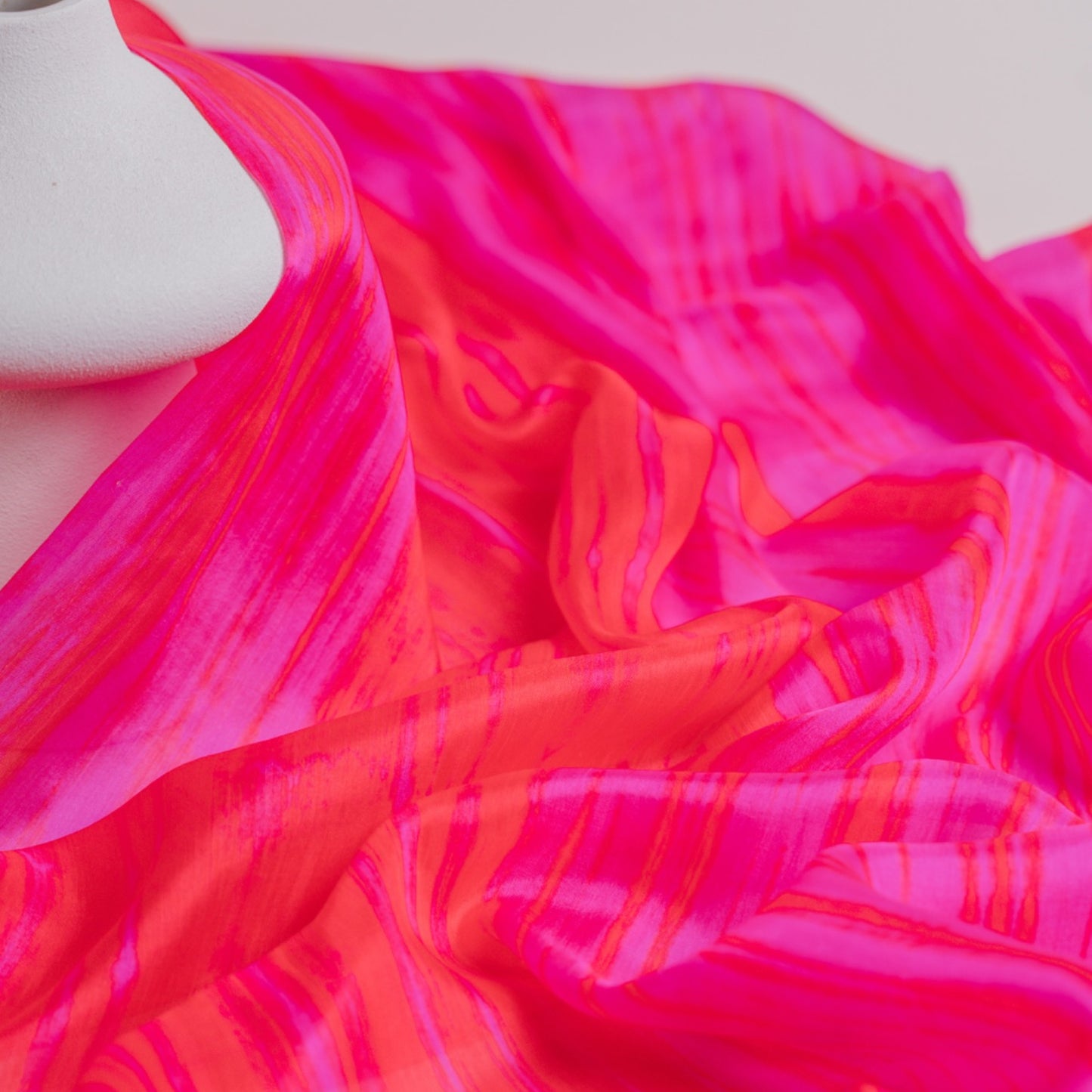 Back view of a model wearing the hot pink brushstroke silk shawl by Silk & Bears
