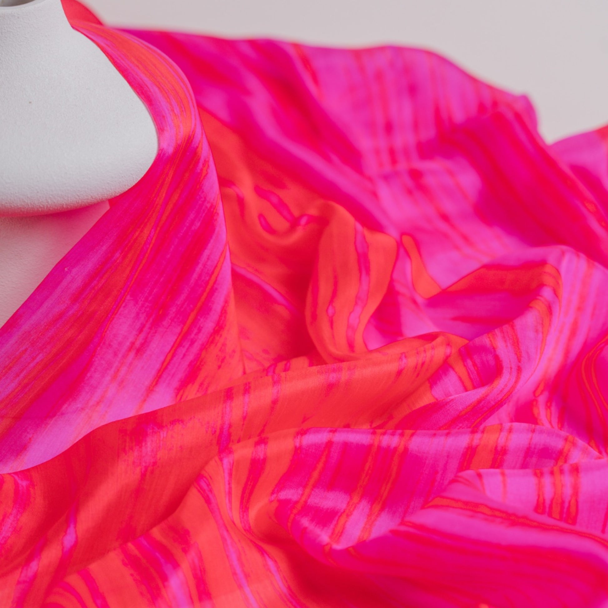Back view of a model wearing the hot pink brushstroke silk shawl by Silk & Bears