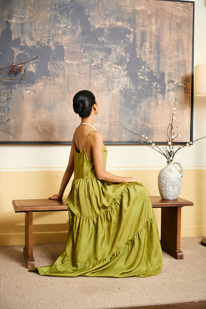 Model wearing the Valentina olive gold silk tiered maxi dress, three-quarter view
