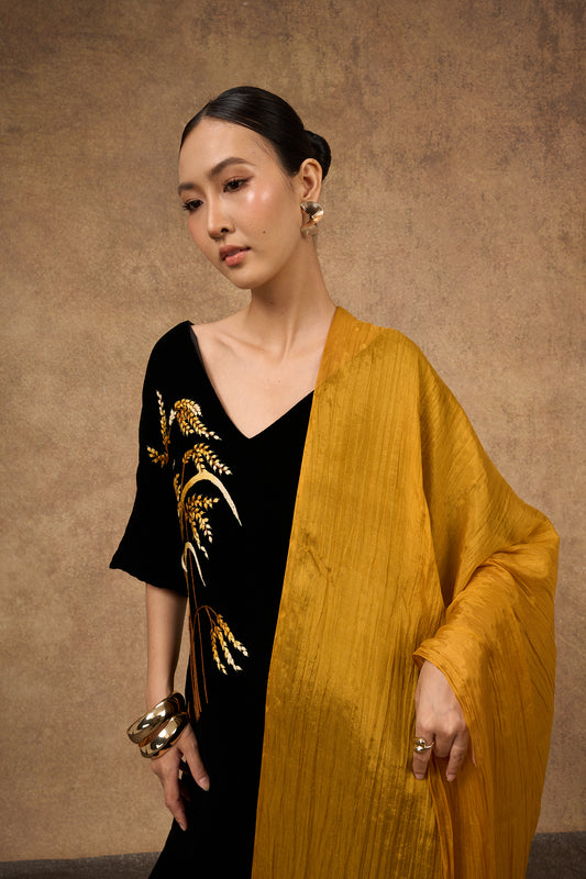 Gold mulberry silk scarf styled loosely around the neck, a lightweight wrap
