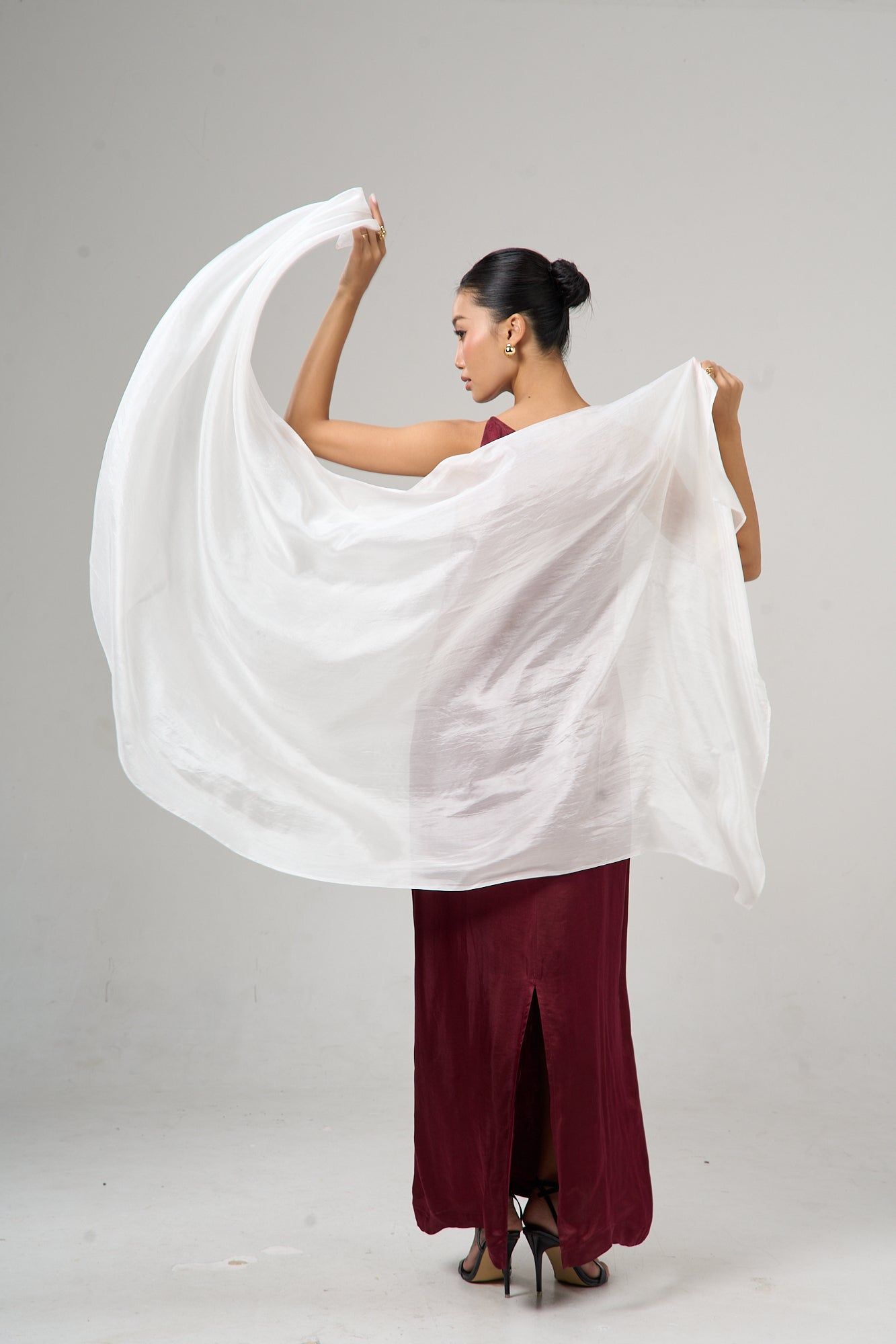 Model wearing a pearl white hand-dyed silk scarf draped over the shoulders