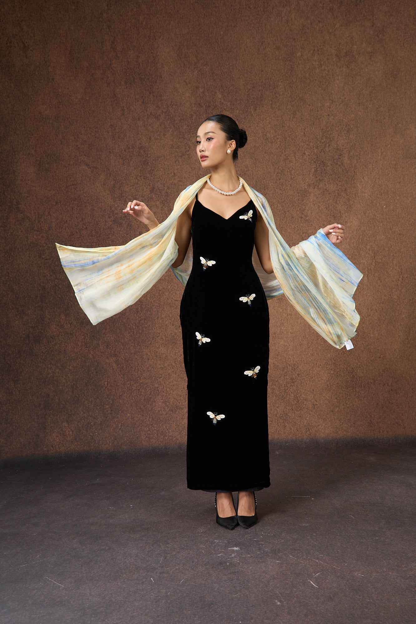 Butter yellow and blue mulberry silk scarf styled loosely around the neck