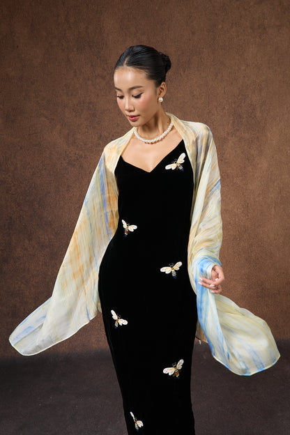 Close-up of the butter yellow and blue brushstroke silk scarf, showing hand-painted texture