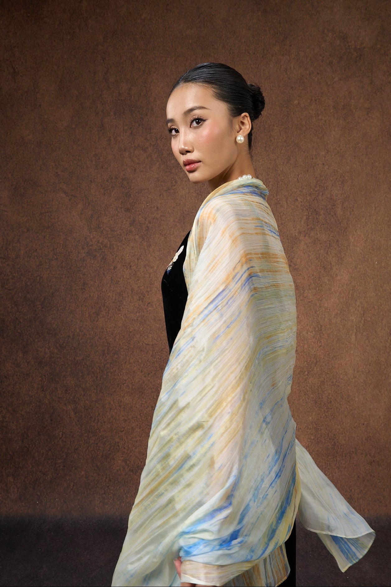 Butter yellow and blue brushstroke silk scarf held open to show the full design