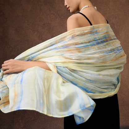Butter yellow and blue brushstroke silk scarf worn as a flowing shawl, hand-dyed mulberry silk