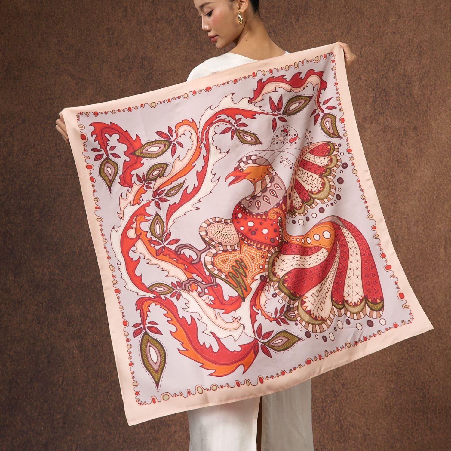 Model wearing the phoenix paisley printed silk twill scarf draped over the shoulders