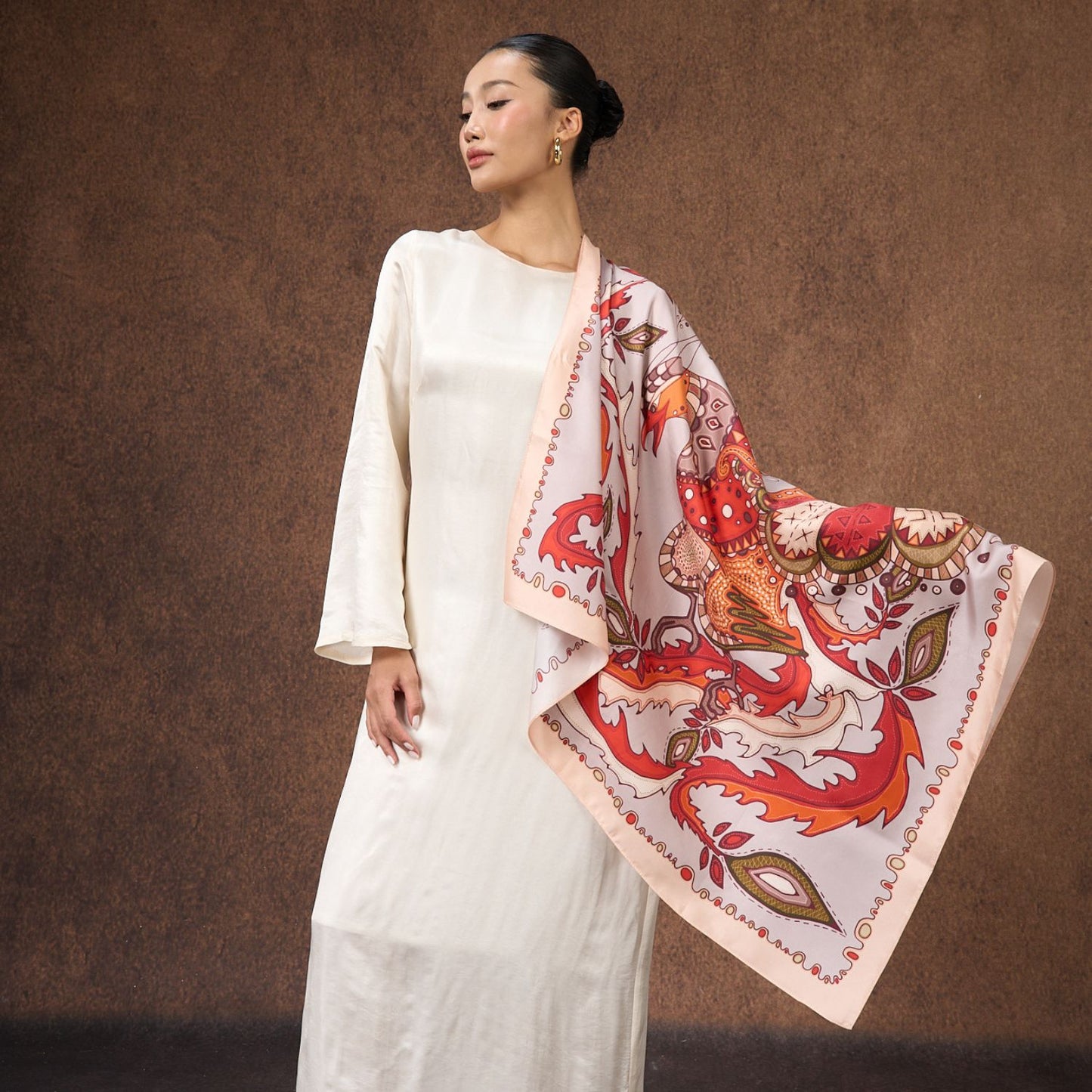 Phoenix paisley printed silk twill scarf worn as an elegant shawl
