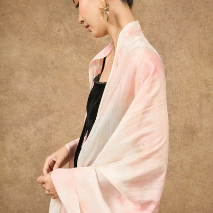Peach orange shibori silk scarf worn as a flowing shawl, hand-dyed mulberry silk