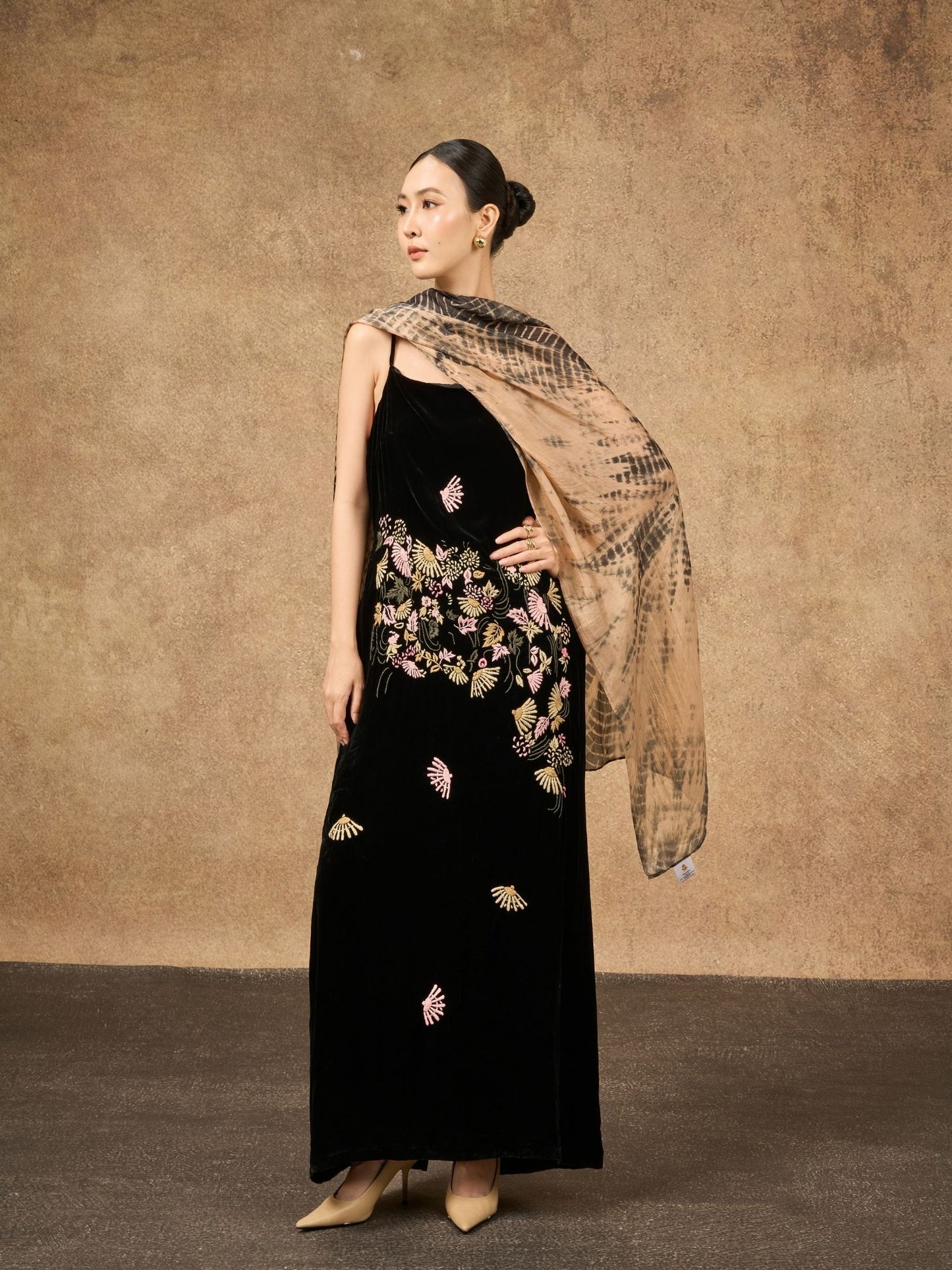 Copper and black shibori mulberry silk scarf styled loosely around the neck