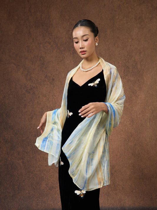 Silk & Bears Butter Yellow Brushstroke hand-dyed mulberry silk scarf from Nha Xa village, draped over shoulders
