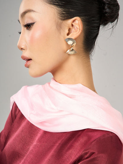 Model wearing a blush pink silk scarf draped as a shawl