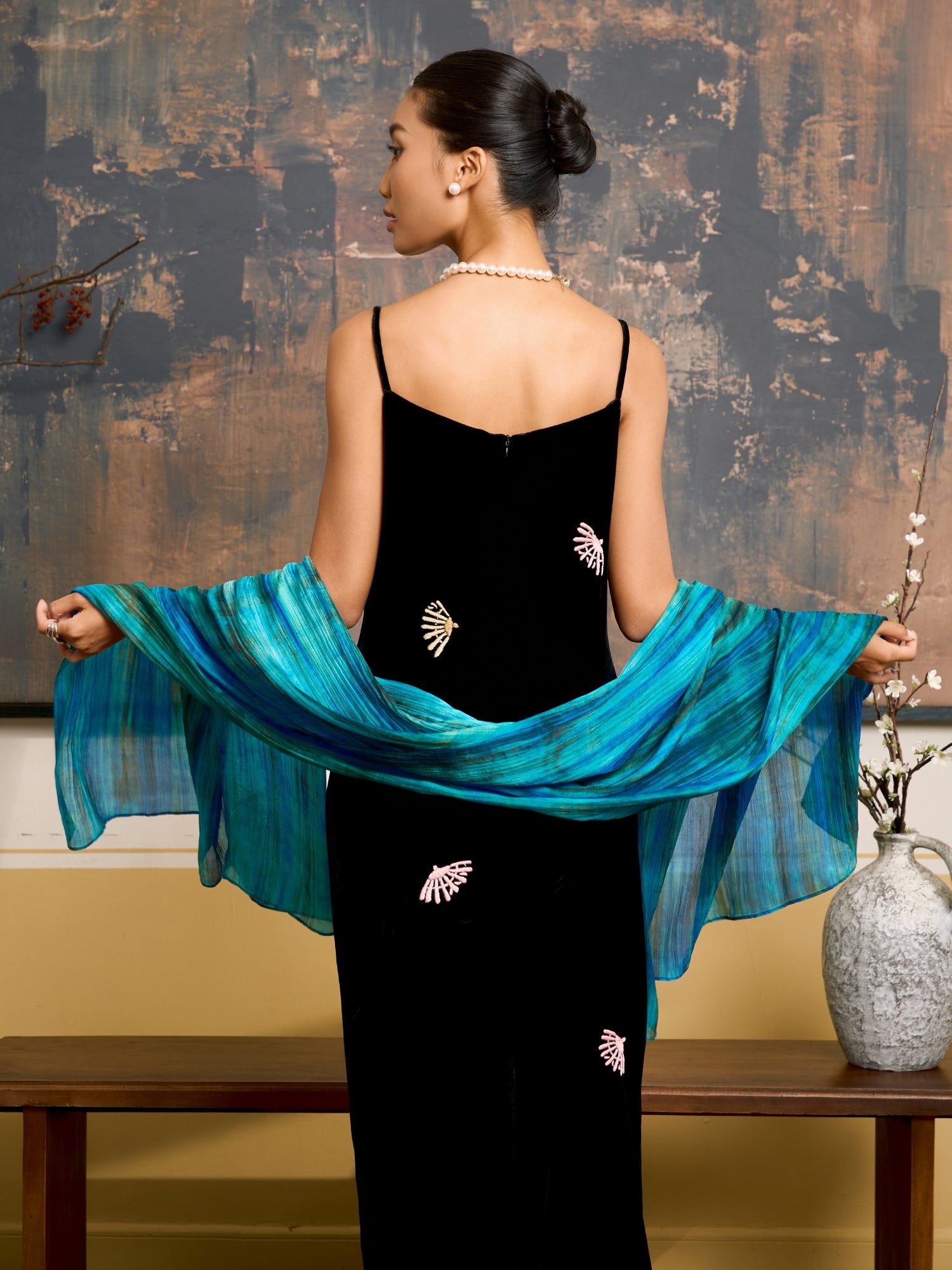 Turquoise blue and emerald brushstroke silk scarf held open to show the full design