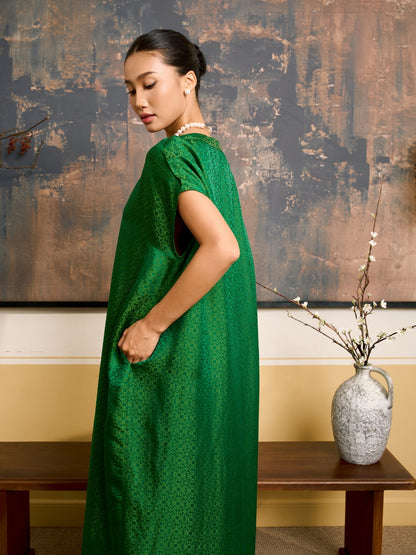 Model wearing the Seraphine emerald jade silk jacquard maxi dress, three-quarter view