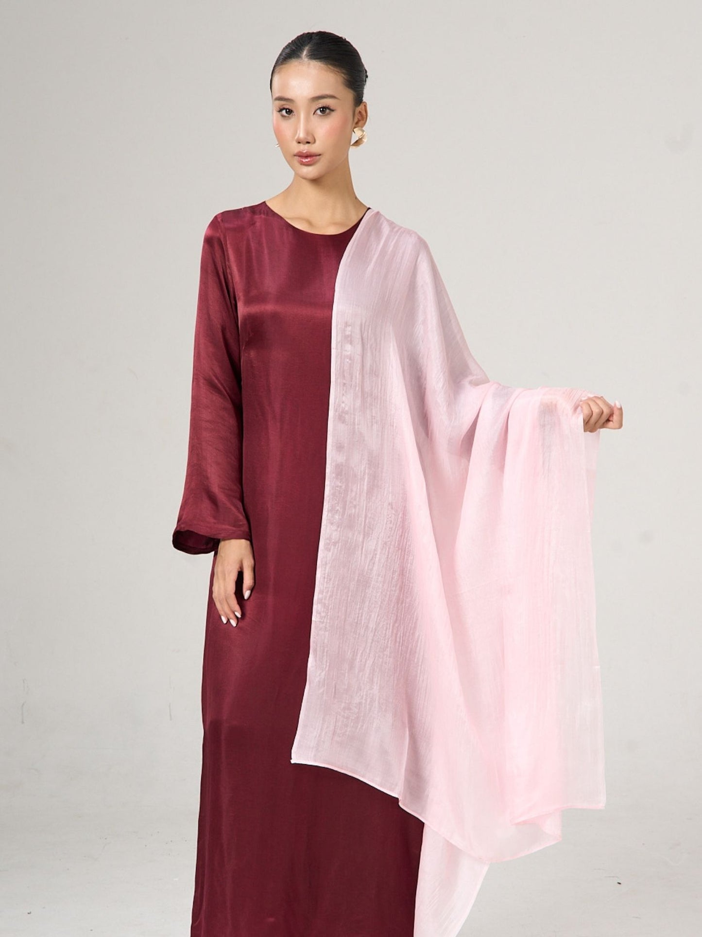 Model wearing a blush pink hand-dyed silk scarf, lifestyle shot by Silk & Bears