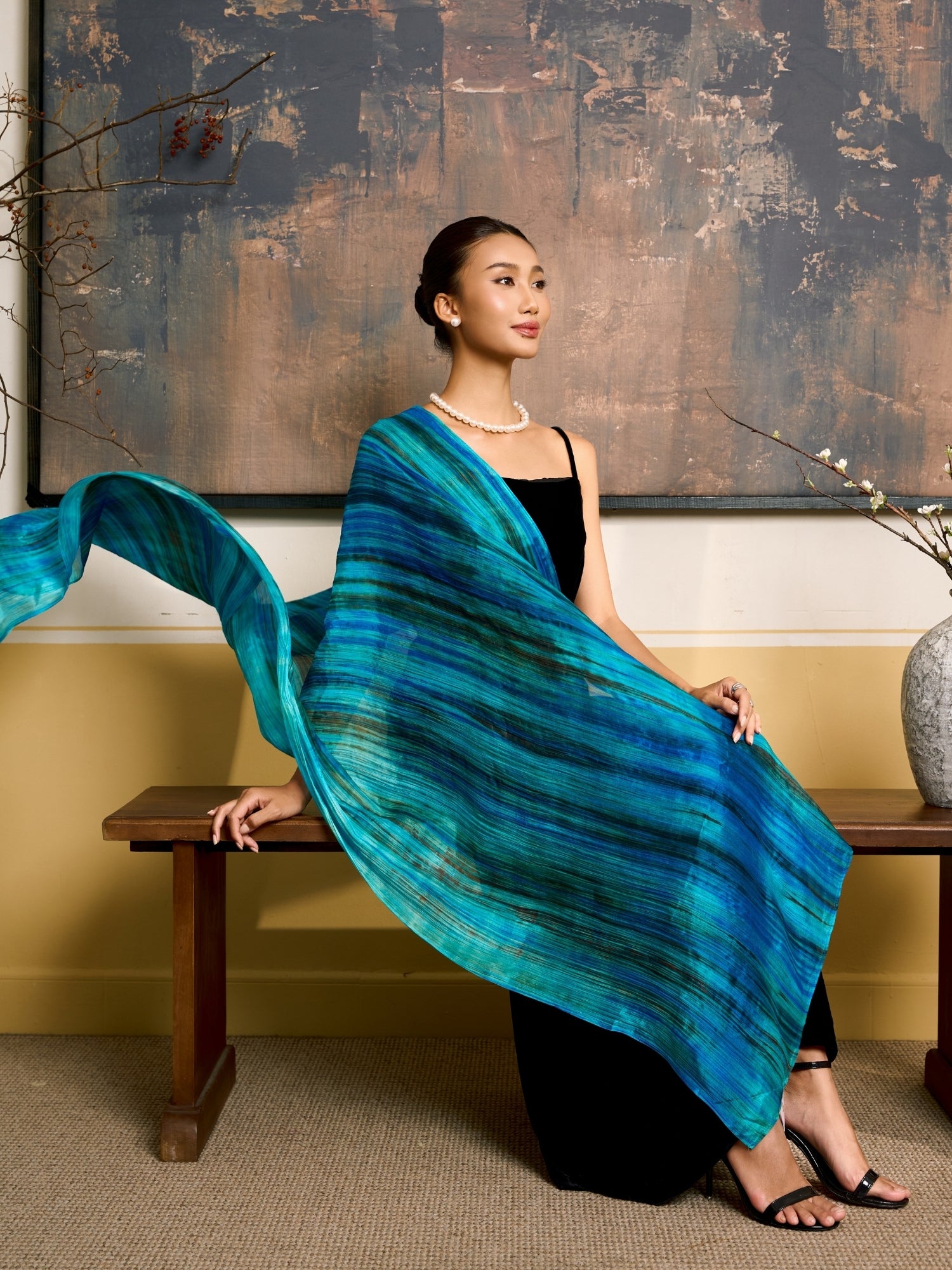 Turquoise blue and emerald brushstroke silk scarf worn as a flowing shawl