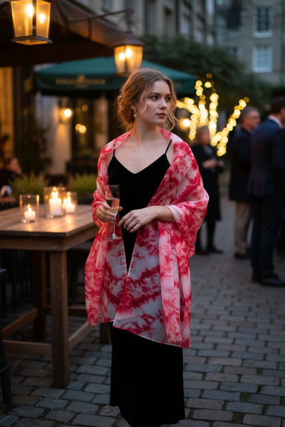 Model wearing a crimson red shibori hand-dyed silk scarf draped over the shoulders