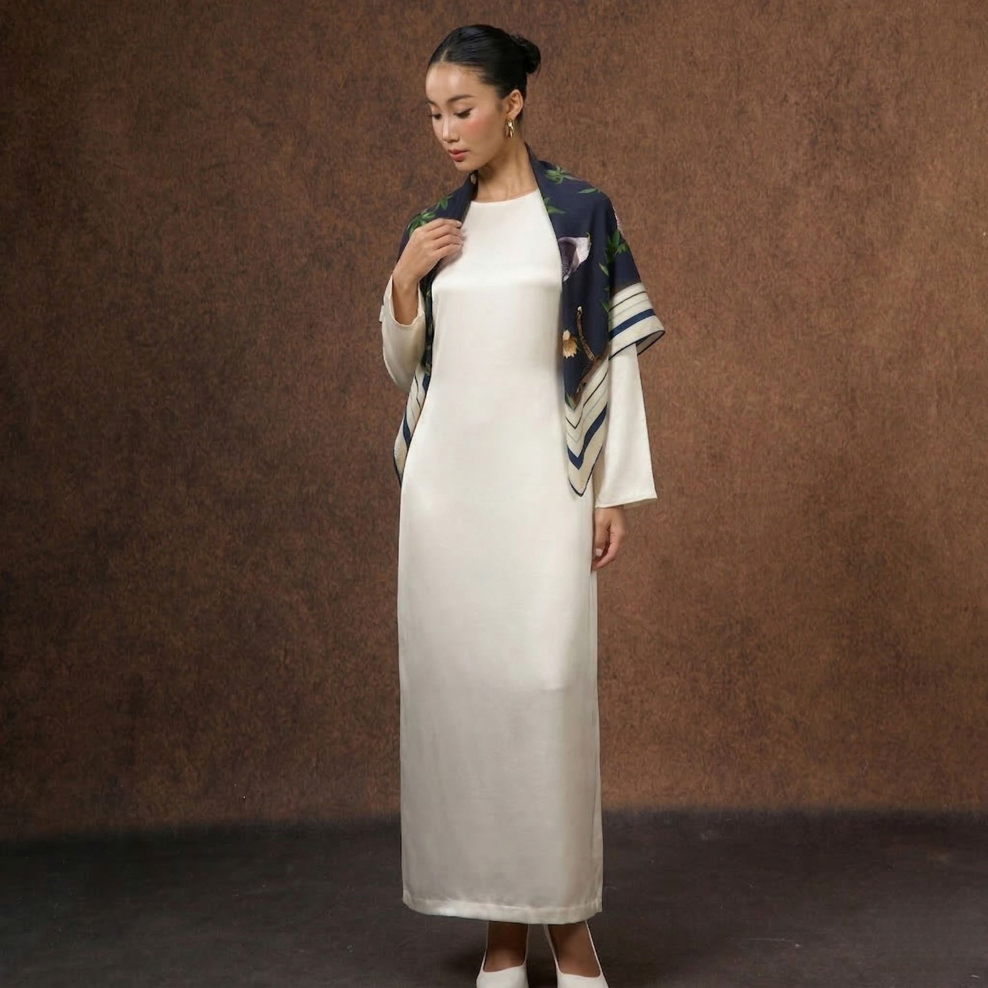 Model wearing the Midnight Safari wool-silk scarf draped over the shoulders