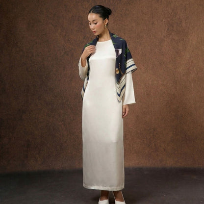 Model wearing the Midnight Safari wool-silk scarf draped over the shoulders
