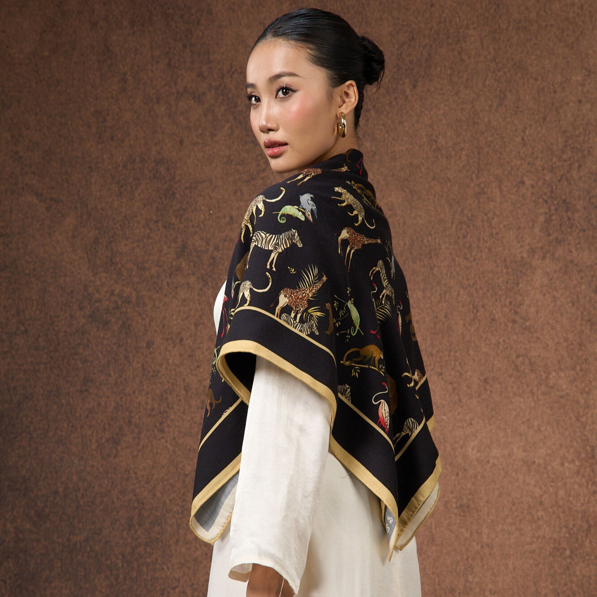 Noir Safari wool-silk scarf worn as an elegant shawl