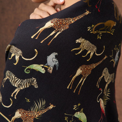Noir Safari wool-silk scarf styled around the neck, animal-motif print