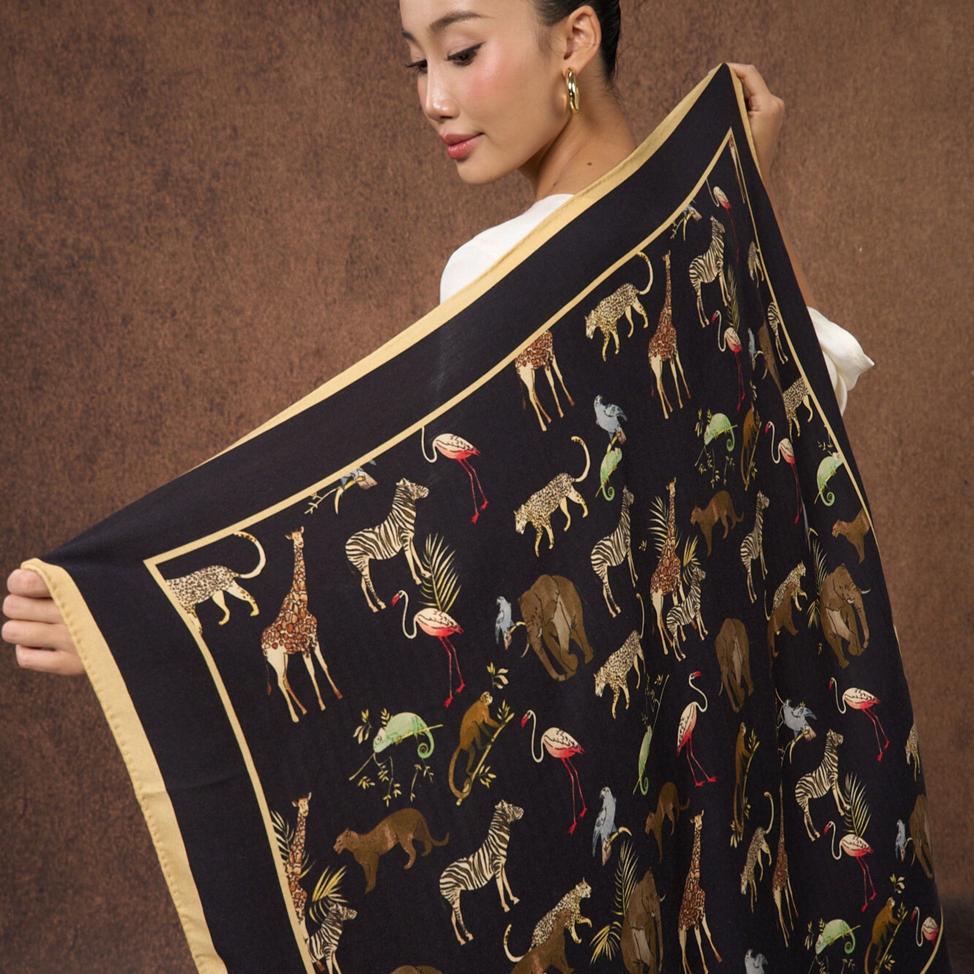 Noir Safari wool-silk scarf laid open to show the full black animal print