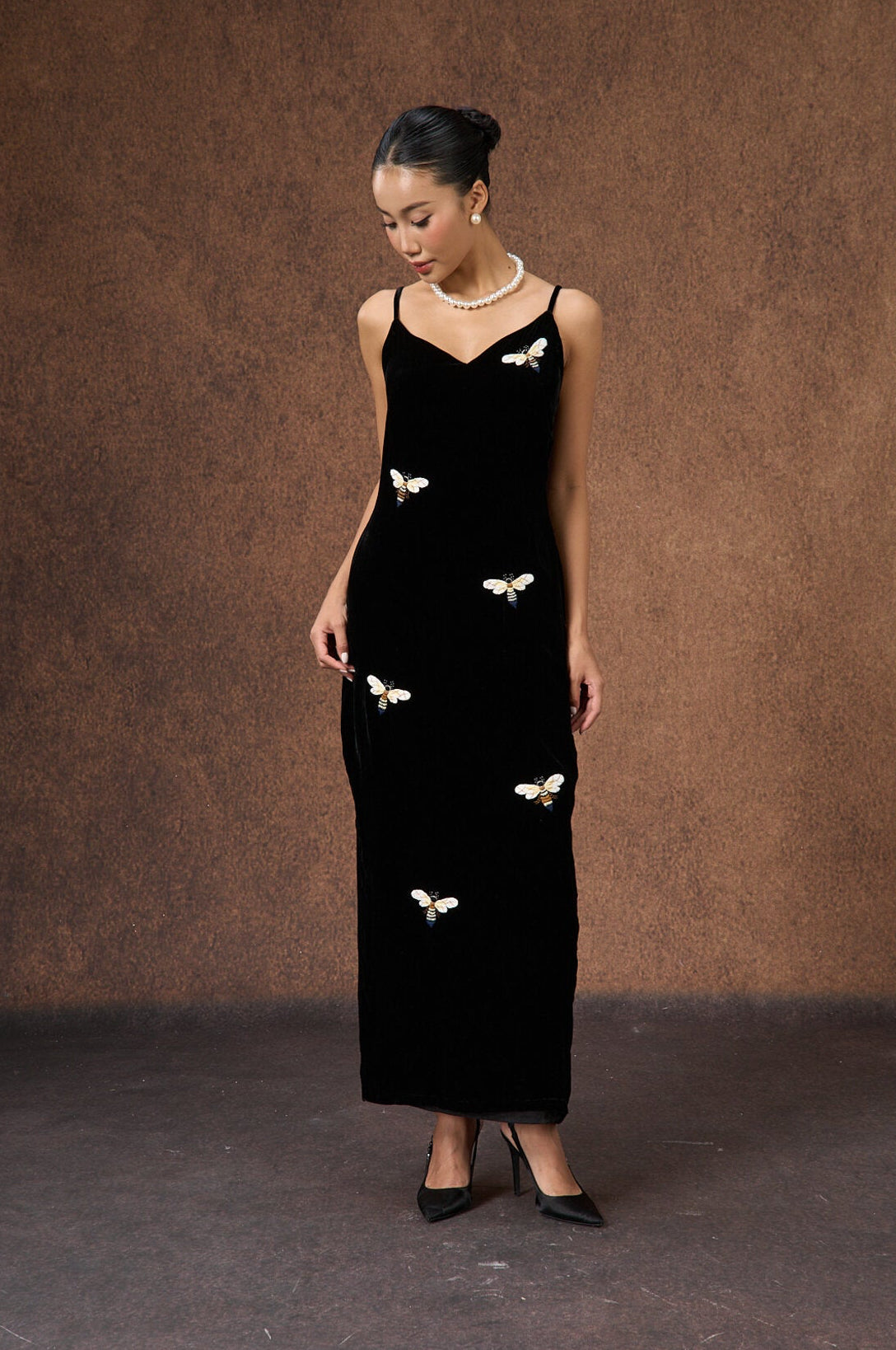 Model wearing the hand-embroidered black bee silk velvet evening dress