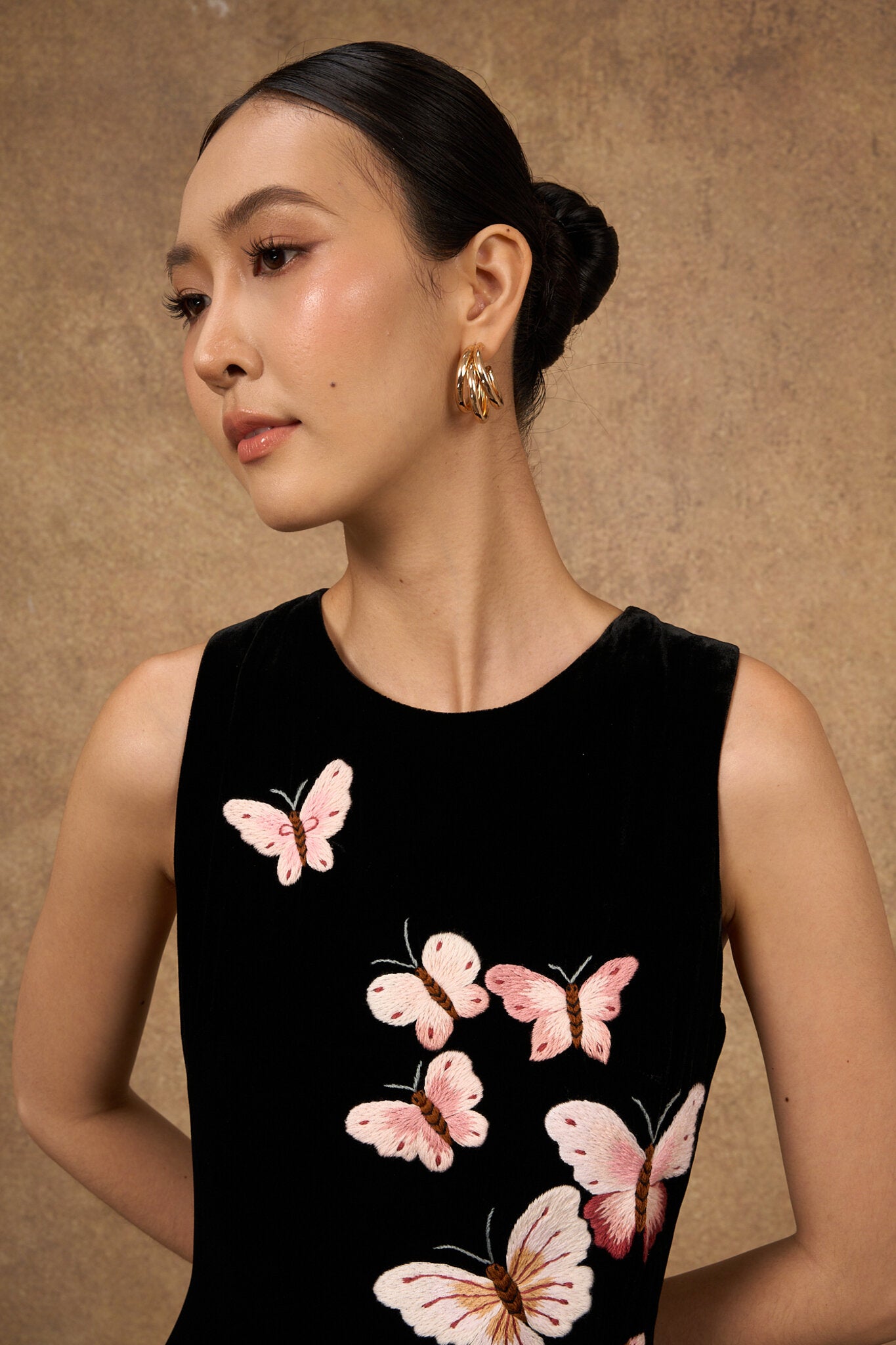 Editorial portrait of the hand-embroidered black butterfly silk velvet dress
