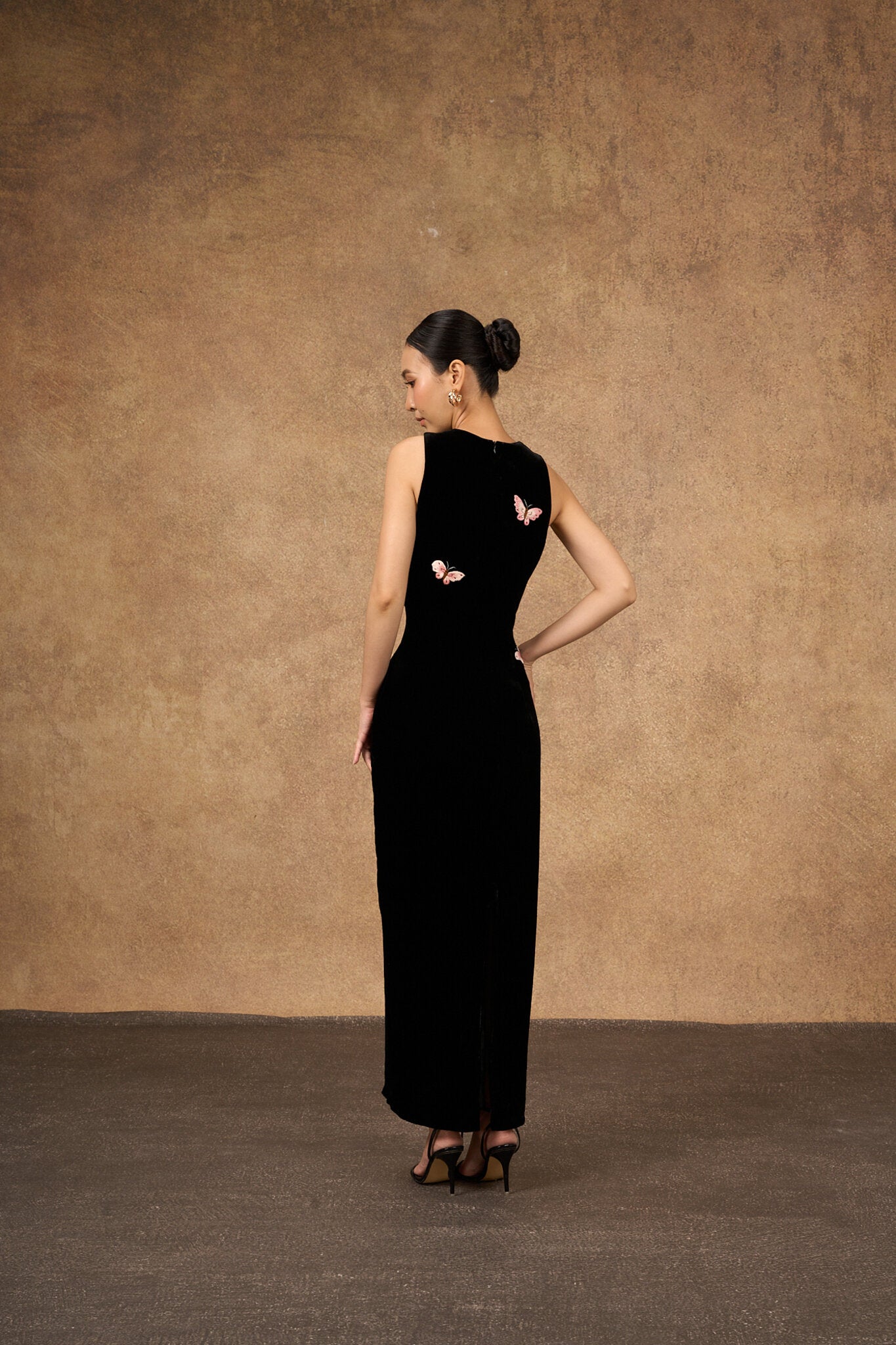Editorial three-quarter view of the black butterfly silk velvet dress
