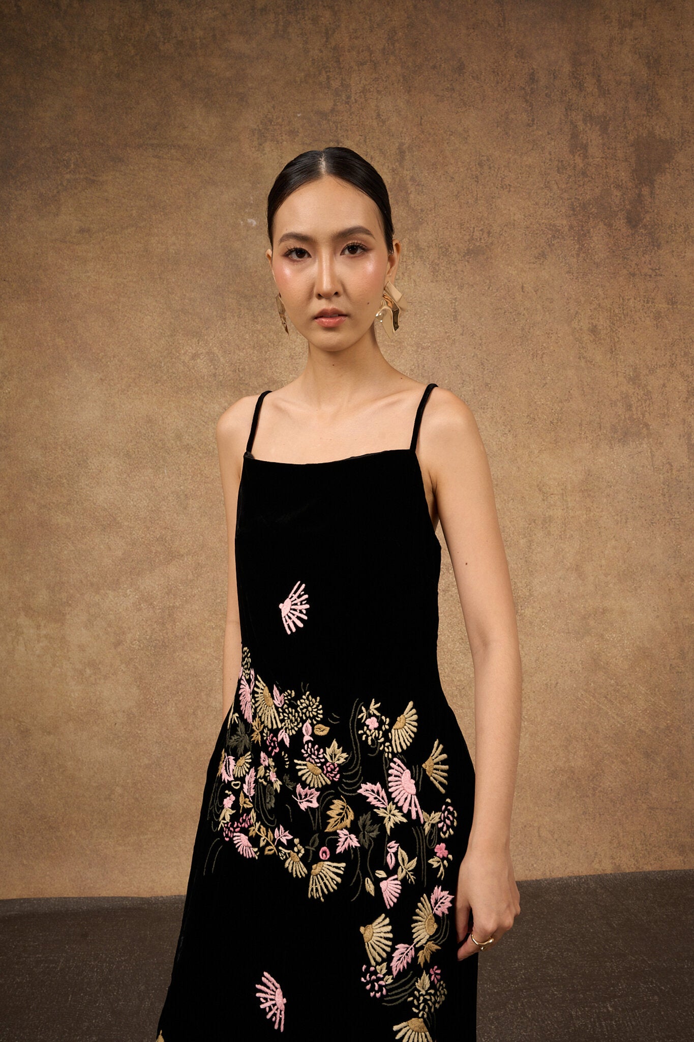 Close-up of the hand-embroidered fan motif on black silk velvet