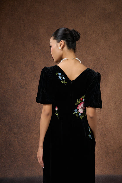 Back view of the hand-embroidered black floral silk velvet puff-sleeve dress