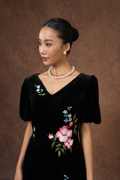 Side view of the hand-embroidered black floral silk velvet puff-sleeve dress