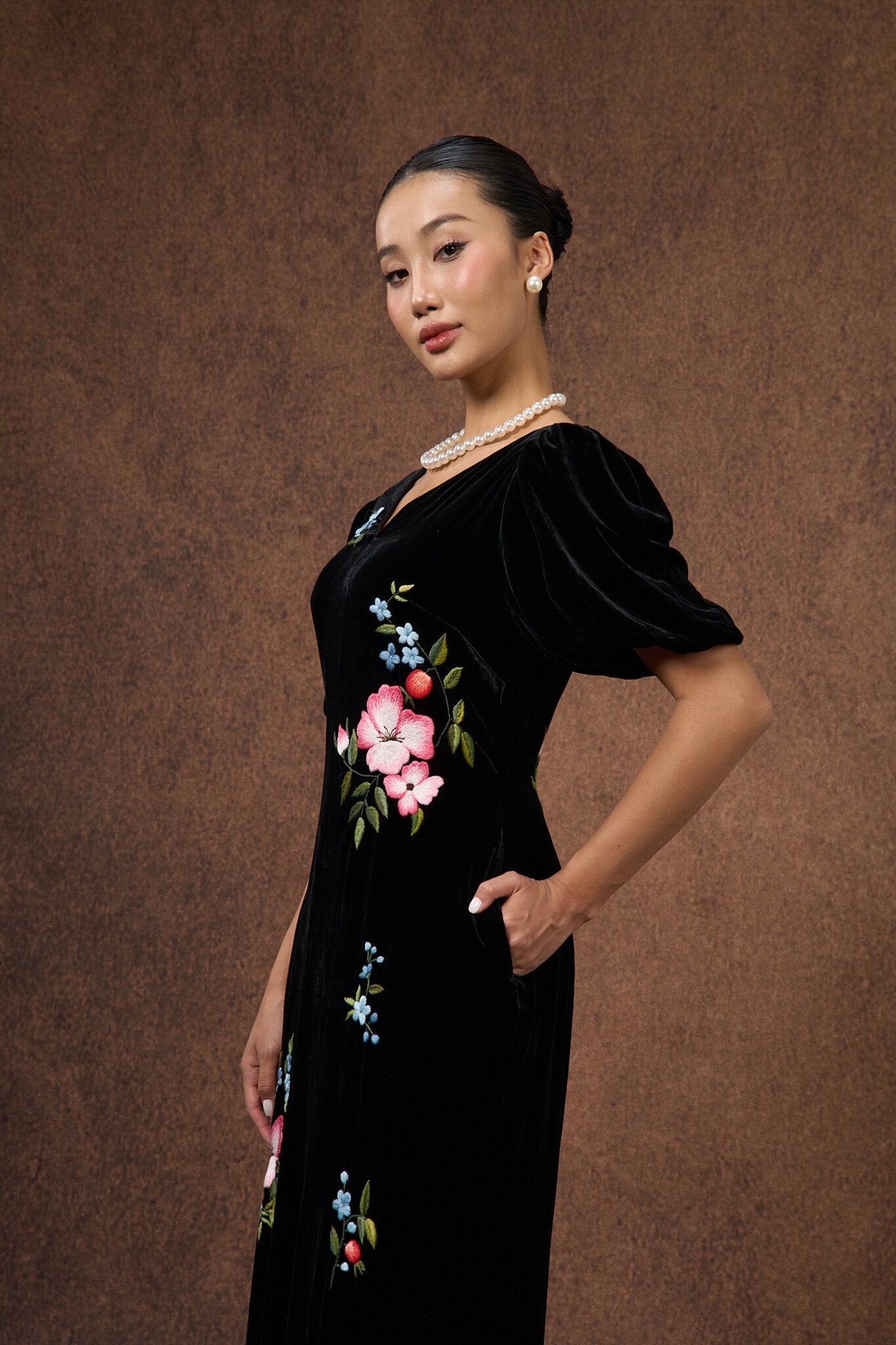 Detail of the bodice of the black floral hand-embroidered silk velvet dress