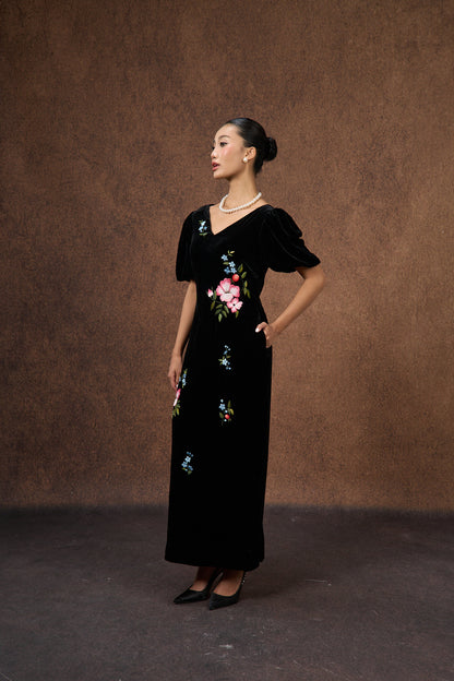 Close-up of the hand-embroidered floral motif on black silk velvet