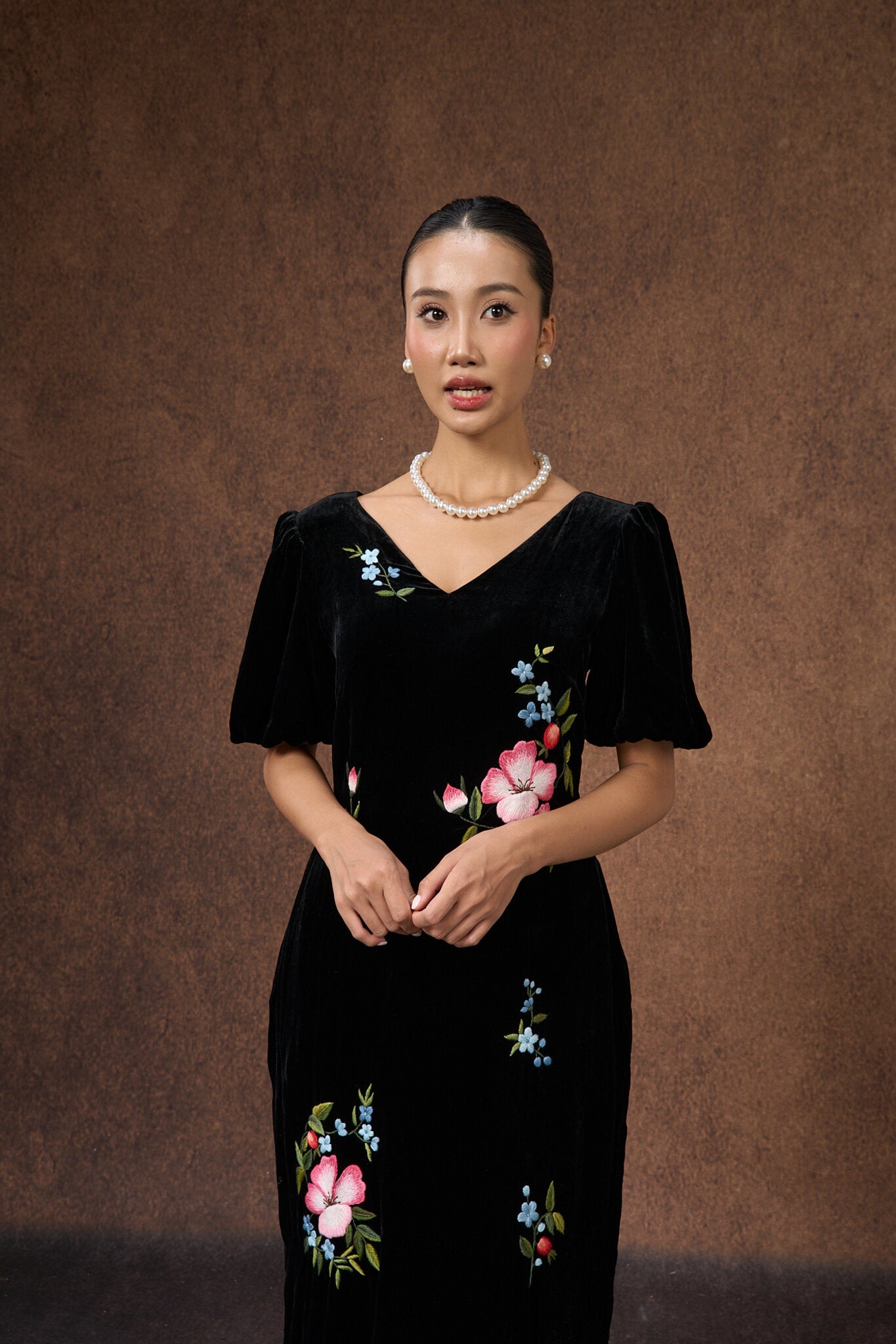 Editorial portrait of the hand-embroidered black floral silk velvet dress