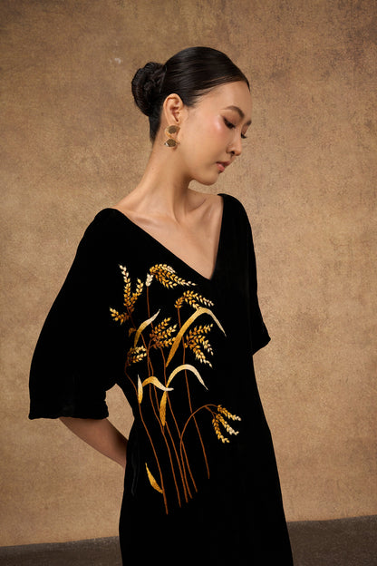 Close-up of the hand-embroidered gold detail on black silk velvet