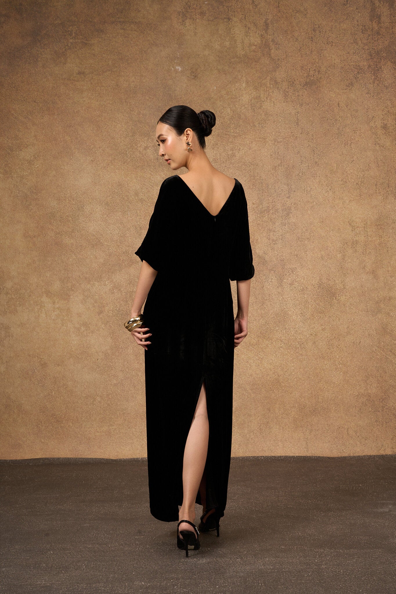 Hand-embroidered black and gold silk velvet dress, three-quarter view
