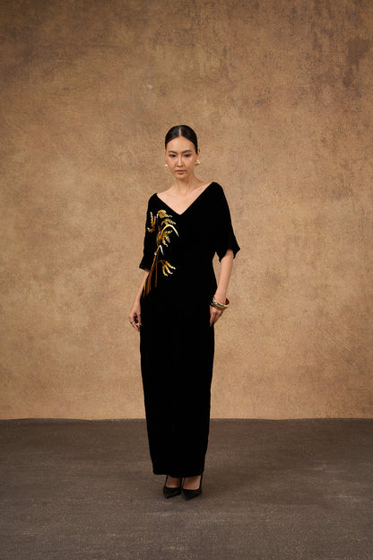 Editorial portrait of the hand-embroidered black and gold silk velvet dress