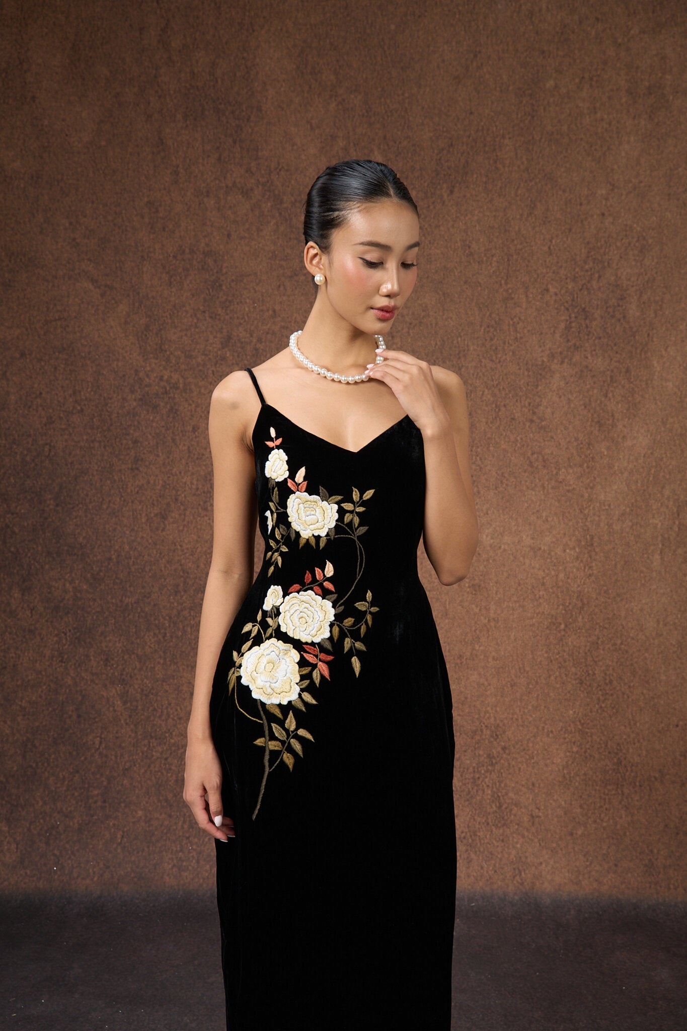 Model wearing the hand-embroidered black rose silk velvet evening dress