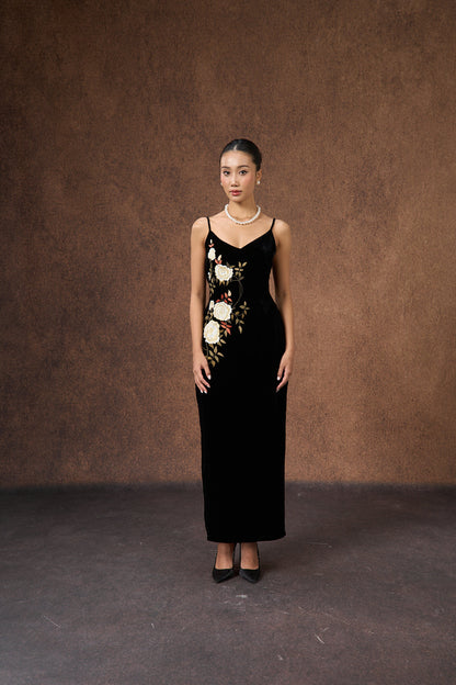 Close-up of the hand-embroidered rose motif on black silk velvet