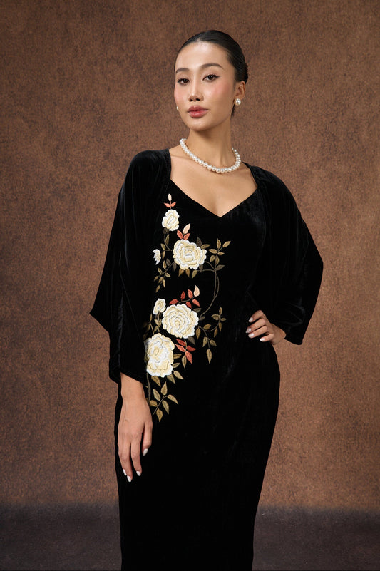 Model wearing the black silk velvet evening bolero wrap over a dress